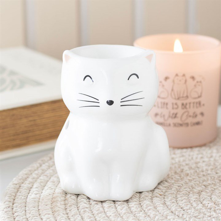 Quemador de wax melts con forma de gatito, vista frontal sobre fondo claro, diseño artesanal tierno y decorativo