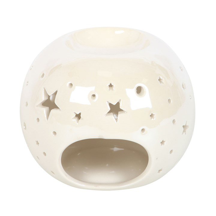 Quemador de wax melts redondo estrellas en contexto decorativo, vista lateral o en uso, estilo artesanal y ambiente acogedor